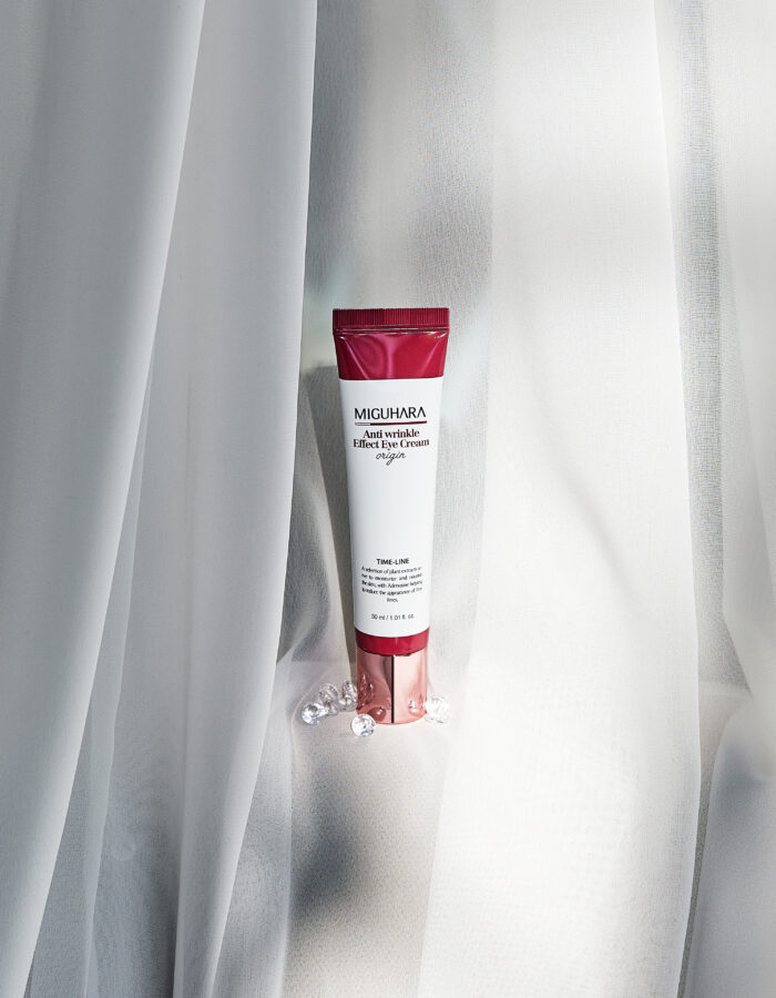 A sleek, metallic silver tube of Miguhara Anti-Wrinkle Effect Eye Cream Origin, 30mL, featuring a precision applicator tip for targeted use. Designed to reduce the appearance of fine lines and wrinkles, this cream offers a luxurious solution for youthful, refreshed eyes.