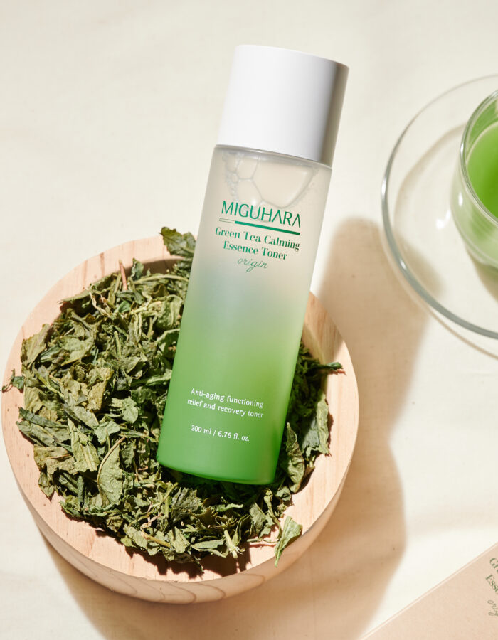 Miguhara Green Tea Calming Essence Toner, 200mL, in a sleek, nature-inspired bottle. Formulated with soothing green tea extract, this toner gently hydrates and calms the skin, making it ideal for sensitive or irritated skin types. Perfect for refreshing and prepping the skin in your daily routine.