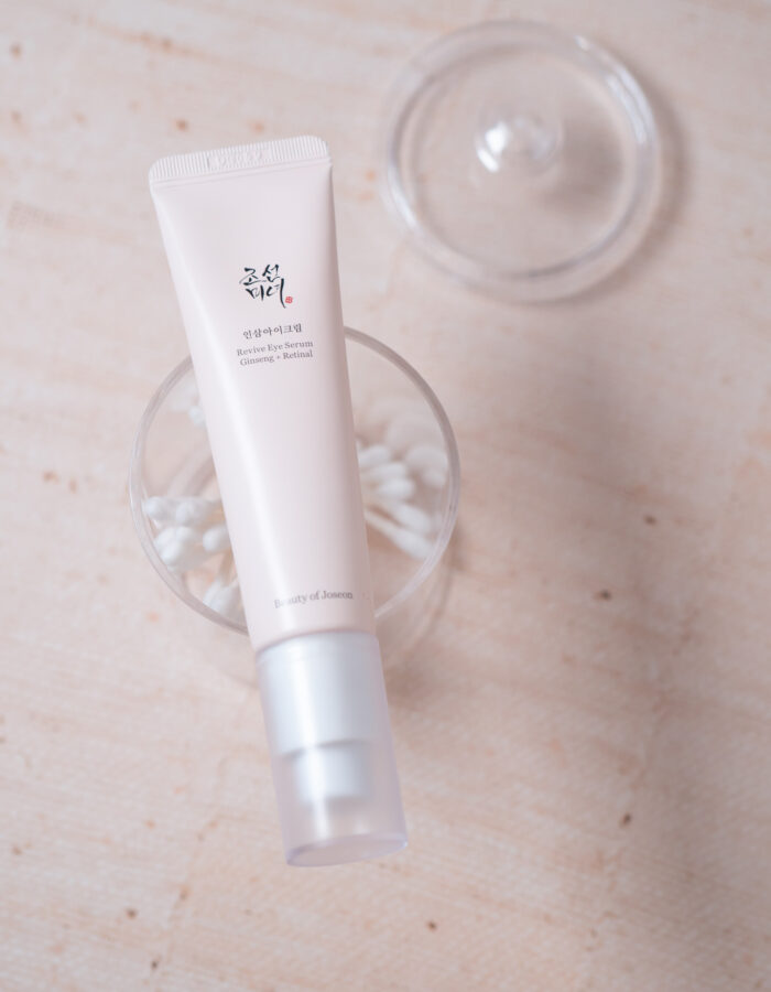 Revive Eye Serum Beauty of Joseon Tube laying on top of a clear plastic container