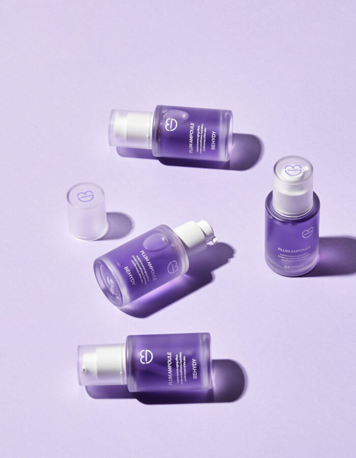 Behydy Plum Ampoule, 30mL, presented in a sleek glass bottle with a dropper for precise application. The design features a plum-inspired theme, emphasizing its nourishing and brightening properties for radiant skin. Perfect for enhancing your skincare regimen.