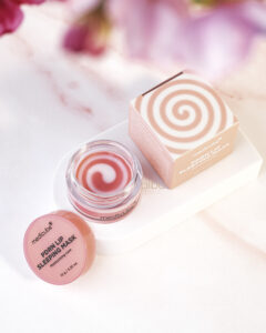 Medicube PRDN Lip Sleeping Mask jar with open lid. Showing pink and white swirl balm next to packaging box.