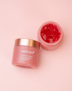 Medicube Collagen Jelly Cream flat lay with open jar on pink background