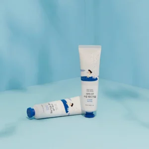 Two tubes of birch hand cream on a light blue background, featuring playful illustrations and product details.