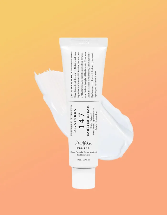 A tube of Dr. Althea 147 Barrier Cream with a smooth cream texture, set against a gradient orange background.
