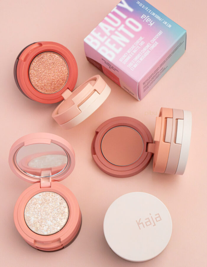 Three stacked eyeshadow compacts in soft pink tones, with a box labeled Beauty Bento in the background.